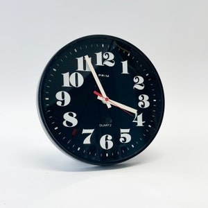 Vinrage black plastic wall clock ,made by PRIM in Czechoslovakia , 1970s,  Mid-century