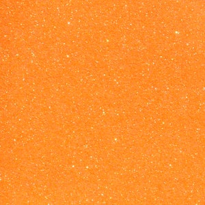 Puede incluir: Primer plano de un fondo de purpurina naranja brillante.