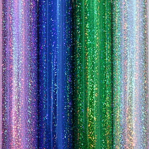 Könnte beinhalten: Vier Rollen schimmerndes Glitzerpapier in den Farben Lila, Blau, Grün und Silber.