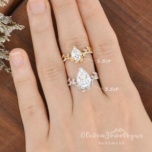 May include: Two pear-shaped diamond engagement rings with delicate leaf and vine details. The ring on the left has a 1.5ct diamond, and the ring on the right has a 3.5ct diamond.  Olivia Jewelry by Us HANDMADE.