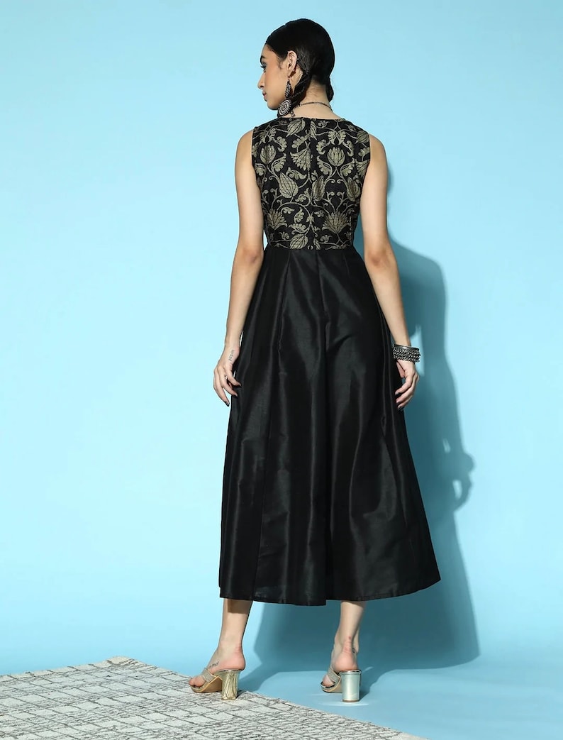 May include: A black sleeveless dress with a gold floral pattern on the bodice and a flowing skirt.