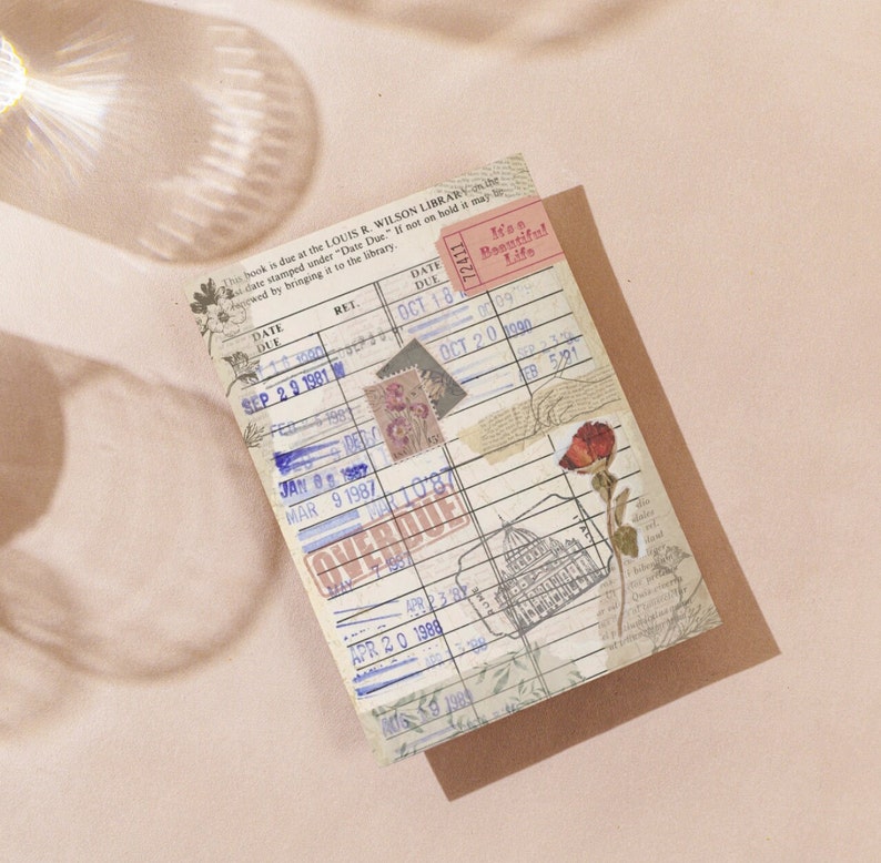 May include: A vintage library card with a pink "It's a Beautiful Life" sticker and a red flower sticker. The card has a date due section with dates from 1981 to 1988. The card is marked "Overdue".