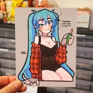 May include: A cartoon illustration of a woman with blue hair wearing a red and black plaid shirt, a black tank top, and black shorts. She is holding a lighter and smoking a cigarette. The text "THANKS FOR THE LIGHT♡" is written above her.