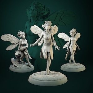 May include: Three miniature fairy figurines with wings, each in a different pose. The fairies are made of a light grey material and have delicate features. They are standing on circular bases.