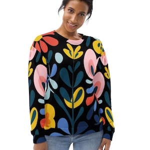 May include: A black sweatshirt with a colorful floral pattern. The flowers are in shades of pink, red, yellow, blue, and green. The sweatshirt has long sleeves and a crew neck.