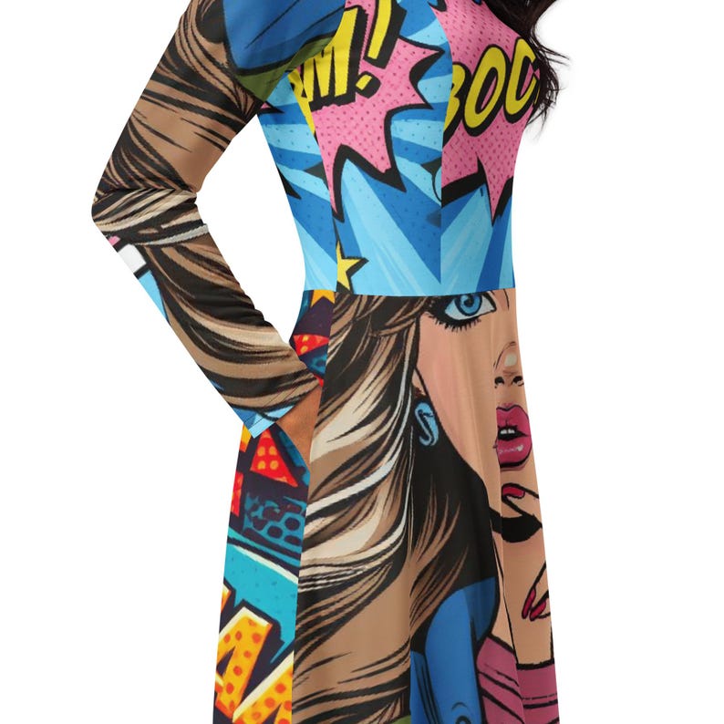 May include: A long-sleeved dress with a comic book-style design. The dress features a vibrant mix of colors, including blue, pink, and brown, with a pop art illustration of a woman's face. The design incorporates speech bubbles and bold text elements.