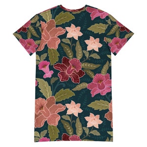 May include: A dark teal t-shirt with a floral print featuring pink, red, and peach flowers with green leaves.
