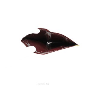 May include: The inside of a burgundy leather wallet with a gold accent. The wallet is open and the inside is visible.