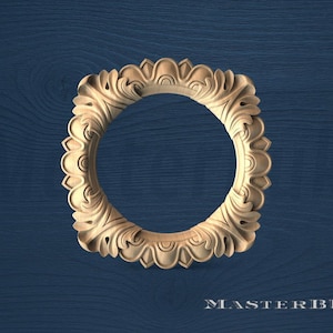 May include: A carved wooden frame with a circular opening, featuring an ornate floral design. The frame is a light tan color and is set against a dark blue wood grain background. The text "MASTERBUK" is at the bottom.