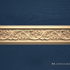 May include: A detailed, light-brown wooden decorative molding with a repeating floral and leaf pattern. The carved design is set against a dark blue background. The text "MASTERBUK" is in the bottom right corner.