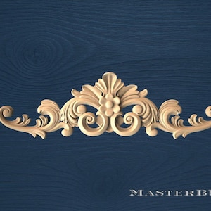 May include: A carved wooden decorative element with a symmetrical design. The piece features floral and scrollwork details, with a central flower and swirling patterns. The text "MASTERBUK" is at the bottom.