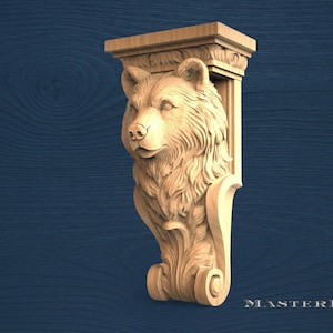 May include: A carved wooden bear head sculpture, with detailed fur and facial features. The sculpture is part of a decorative architectural element, with a rectangular top and ornate scrollwork. The piece is made of light-coloured wood.