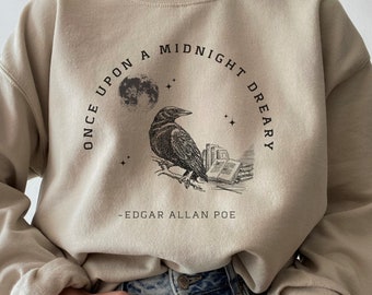 May include: A beige sweatshirt with a black raven and the text "Once upon a midnight dreary" and "Edgar Allan Poe" printed on the front.