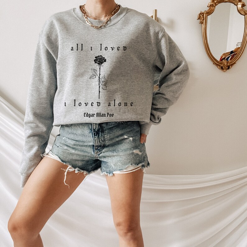 May include: Gray cropped sweatshirt with a black rose and the text "all I loved I loved alone Edgar Allan Poe".