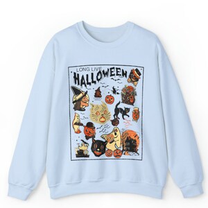 May include: Light blue sweatshirt with a vintage Halloween graphic print featuring a witch, cats, pumpkins, ghosts, and the text "Long Live Halloween".