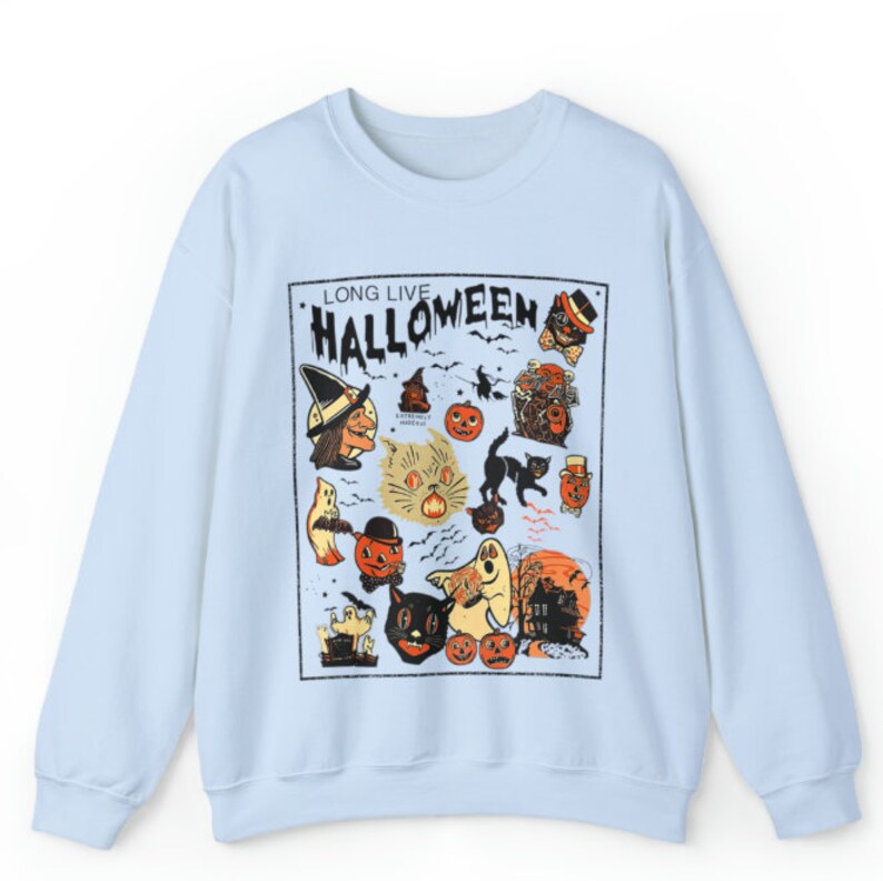 May include: Light blue sweatshirt with a vintage Halloween graphic print featuring a witch, cats, pumpkins, ghosts, and the text "Long Live Halloween".