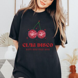 May include: Black t-shirt with a red cherry graphic featuring two disco balls. The text "Club Disco" and "Happy Hour Every Hour" is printed in red.