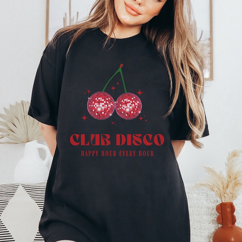 May include: Black t-shirt with a red cherry graphic featuring two disco balls. The text "Club Disco" and "Happy Hour Every Hour" is printed in red.