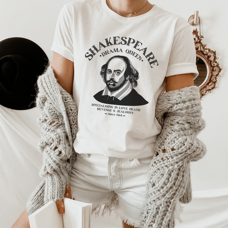 May include: White t-shirt featuring a black and white illustration of William Shakespeare. The text reads "Shakespeare - Drama Queen - Specialising in love, death, revenge & jealousy - Since 1564 - "