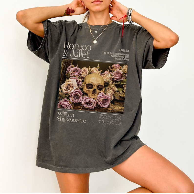 May include: A dark gray oversized t-shirt with a graphic print of a skull surrounded by roses. The text "Romeo & Juliet" and "William Shakespeare" are printed on the shirt.