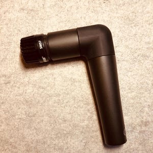 May include: A black Shure SM57 microphone with a 90-degree angled connector.