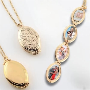 May include: Gold-colored oval locket necklaces. One locket features a floral design, while another is plain. A third necklace displays a series of connected oval lockets, each holding a small photograph. The lockets are on delicate gold chains.