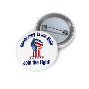 May include: White button with the text "Democracy is our Right" in blue, encircling a graphic of a fist in the colors of the American flag. Below the fist is the text "Join the Fight!" and five blue stars.