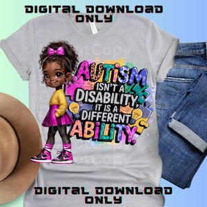 May include: A grey t-shirt with a colourful graphic design featuring a cartoon girl and the text "Autism isn't a disability, it is a different ability."