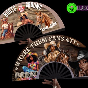 May include: Two black hand fans with illustrations of cowgirls and horses. One fan reads "BOOTS ON THE GROUND TRAIL RIDE." The other fan reads "WHERE THEM FANS AT? RODEO Show Down." The fans have black ribs and are held by a hand.