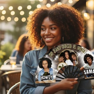 May include: A woman smiles while holding a black and white fan with photos and text. The fan has the words "25 and such a vibe" and the names "Howdy" and "Saman". The background is a blurred outdoor setting with string lights.