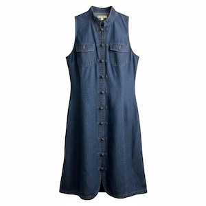 May include: Sleeveless denim dress in a medium blue wash. The dress features a mandarin collar, two chest pockets, and a series of decorative buttons down the front. The dress has a slight A-line shape and a front slit at the hem.