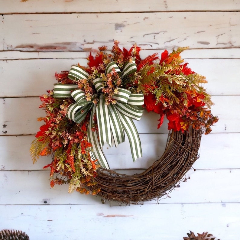 Minimalist final wreath with fall foliage and a green cabana striped green bow