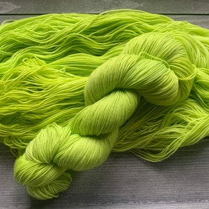 May include: A skein of bright green yarn, perfect for knitting or crocheting projects.