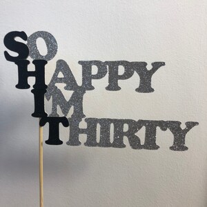 May include: Black and silver glitter cake topper with the text "So Happy I'm Thirty".