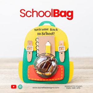 May include: A colorful papercraft backpack with the text "SchoolBag" in red. The backpack features a yellow top, green body, and red pocket. Inside is a notebook, pencil, and a clear ball filled with candy. The text "Welcome Back to School!" is also visible.
