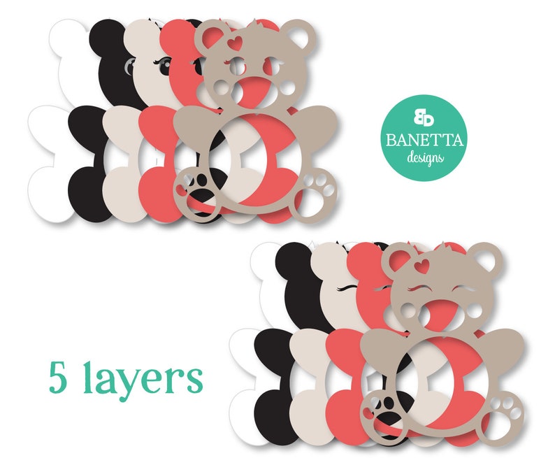 May include: Five layered die cut template of a teddy bear with a heart on its chest. The layers are white, black, beige, and pink.