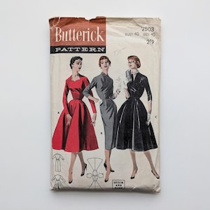 May include: Vintage Butterick sewing pattern with illustrations of three dresses. The pattern cover shows a red dress, a grey dress, and a black dress. The text on the cover includes "Butterick PATTERN" and the pattern number 7503.