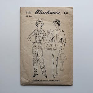 May include: Vintage sewing pattern by Blackmore, featuring illustrations of two women in coordinated outfits. The pattern includes a jumpsuit and a jacket with pants. The text on the pattern reads "9171 38 Bust" and "Turnings are allowed on this pattern."