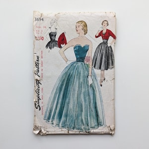 May include: A vintage Simplicity Pattern, size 14, with illustrations of evening dresses. The cover shows a teal strapless gown with a full skirt, and a red bolero jacket. Made in Great Britain.