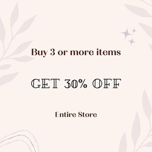 May include: A light pink graphic sign featuring dark brown text that reads Buy 3 or more items, GET 30% OFF, and Entire Store. The design includes subtle, light-colored leaf illustrations in the corners and two small star icons.