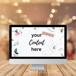 May include: A computer monitor on a wooden table with a white background. The screen displays the text "your content here" with a floral arrangement and twine.