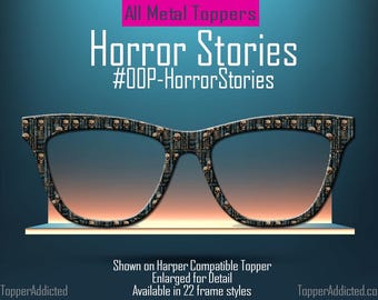 Peut inclure: Lunettes avec un motif de crâne sur les montures, avec le texte "Horror Stories" et "#OOP-HorrorStories". L'image comprend également le texte "All Metal Toppers" et "Shown on Harper Compatible Topper".