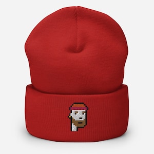 May include: Red knit beanie with a pixelated embroidered image of a person wearing a hat and sunglasses.