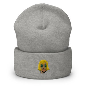 May include: Gray beanie with a pixelated embroidered image of a woman with blonde hair, green eyes, and red lips.