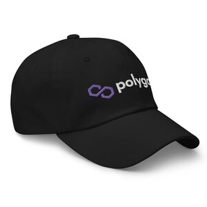 May include: Black baseball cap with a curved brim. The cap features the word "polygon" in white script and a purple infinity symbol logo on the front. A classic, adjustable hat.