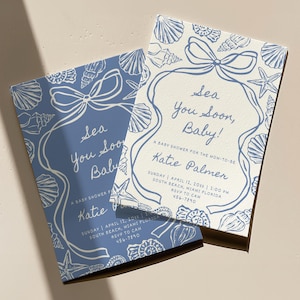 May include: Two baby shower invitations with a nautical theme. The invitations feature a blue and white seashell design with the text "Sea You Soon, Baby!" and event details. The invitations are rectangular.