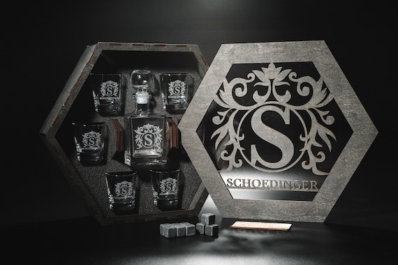 A full personalized whiskey decanter set with engraved glasses and whiskey stones — a legitimately impressive gift that looks great on a bar cart.