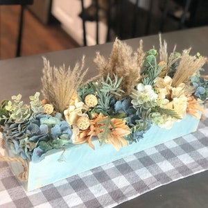 Beachy neutrals floral centerpiece with blue planter box and rope handles