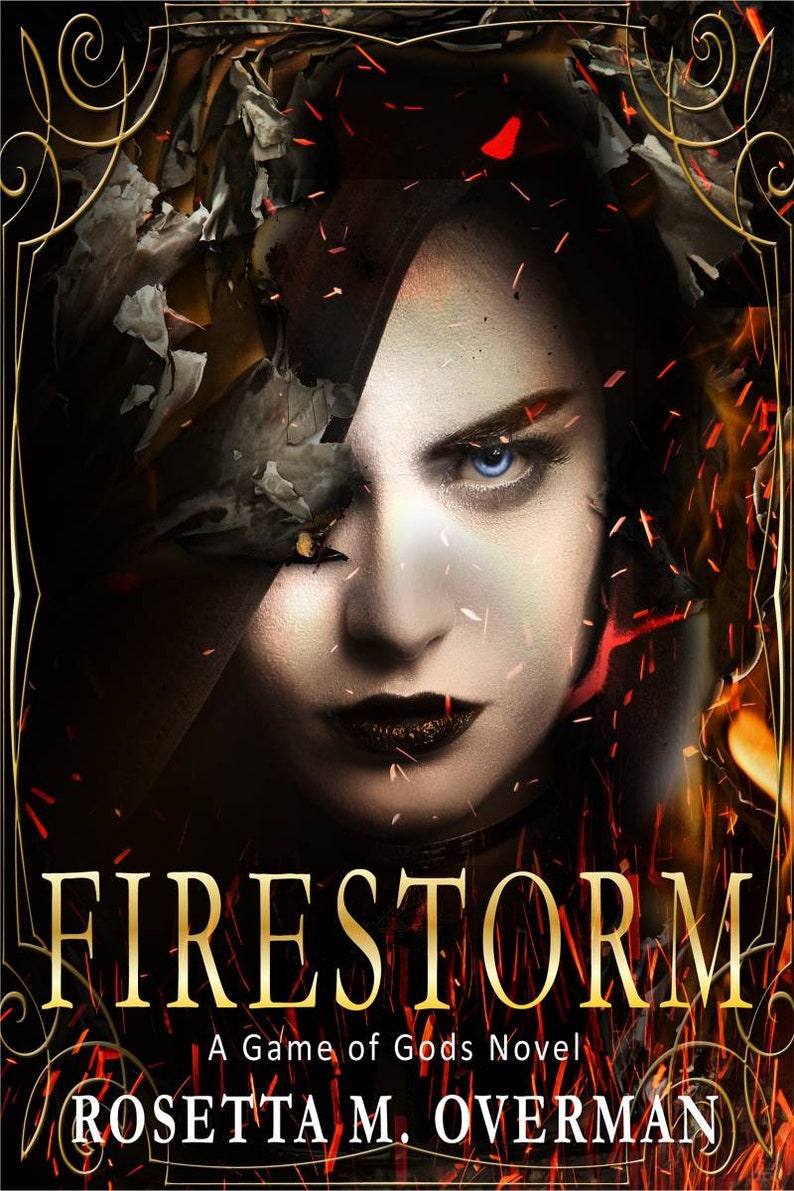 May include: Book cover for "Firestorm: A Game of Gods Novel" by Rosetta M. Overman. The image features a woman's face with intense blue eyes, dark lipstick, and a fiery background. The title is in gold lettering.