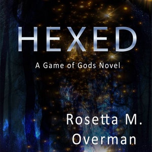 May include: Book cover for "Hexed: A Game of Gods Novel" by Rosetta M. Overman. The cover features a dark, cosmic background with the title in silver, a partial face, and a celestial design.